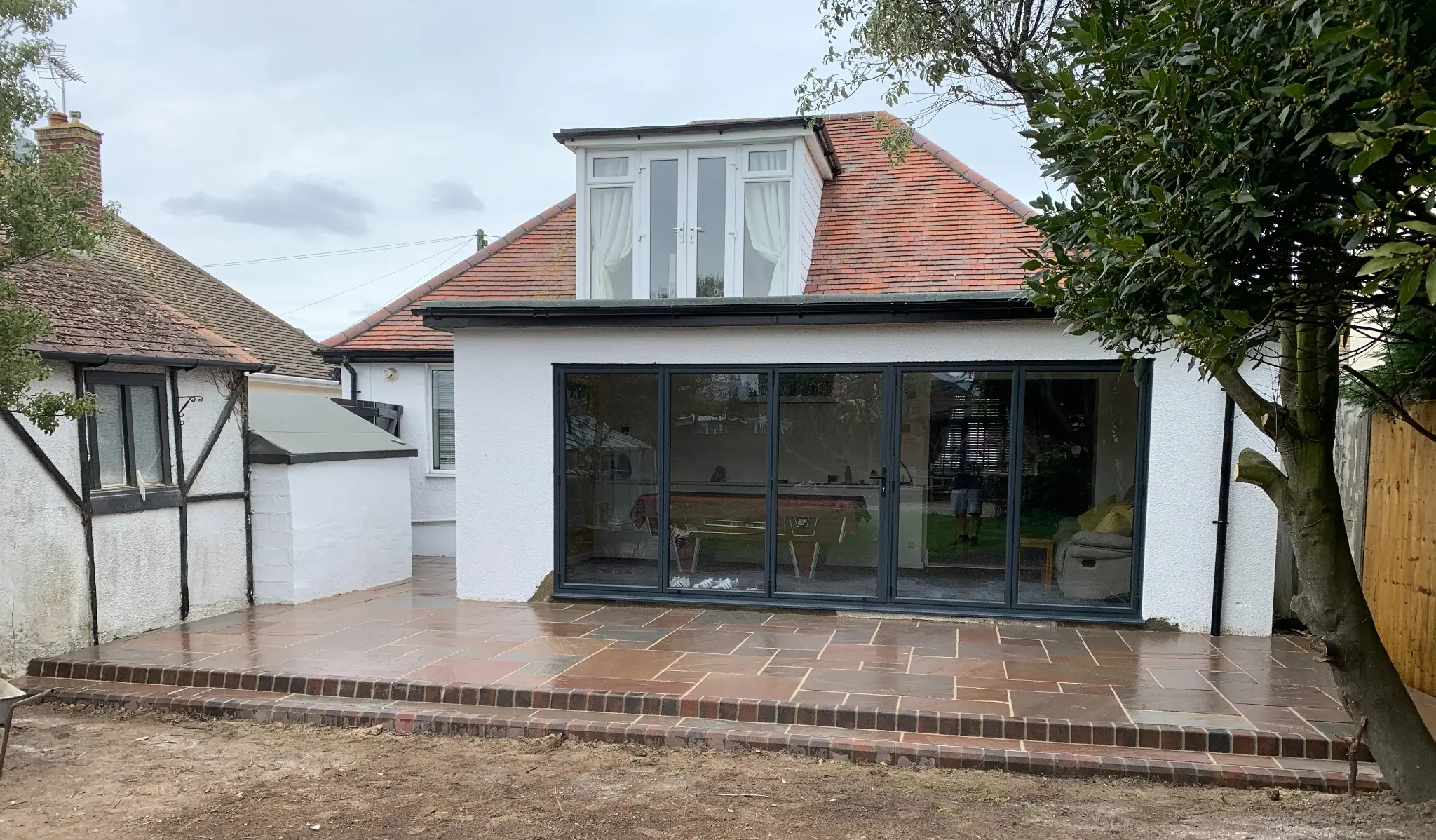 Completed rear extension, bifold doors and patio by DRC Builders