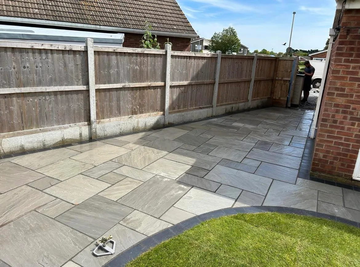 Completed grey patio beside the garden