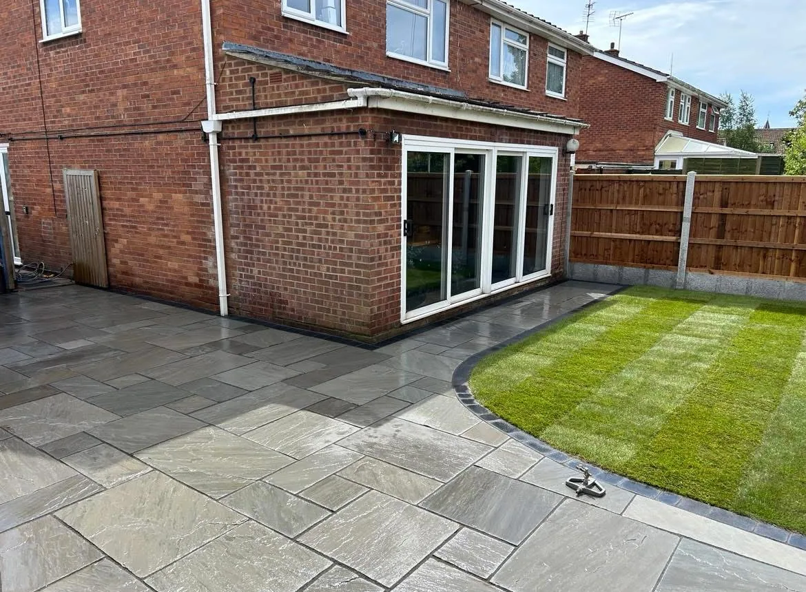 Completed grey patio beside the garden